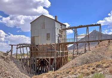 Tonopah Historic Mining Park:  .  According to local history, miner Jim Butler was angrily chasing a runaway donkey in 1900, picked up a rock to throw at the animal, found it surprisingly heavy, and realized he had stumbled upon a wealth of untapped silver ore.  . 
Built in 1905, the Grizzly housed a hand-sorting crew for the silver ore: good ore went into the bins, bad ore when out on the waste pile.  .  The Silver Top Mine, which operated until 1948, features one of three complete hoisting works in the park property.  .  The total sum of precious metal mined at the Tonopah Mining Park is valued at more than a billion dollars in modern currency.  .  The Mizpah Mine, the first one opened by Jim and Belle Butler, was by far the richest of the town's many mines. Its mineshaft extends down about 600 feet.  .  The slanted structure of the powder magazine was used for storage of dynamite and candles during the first few years of operation.  .  The Burro Tunnel was one of Jim Butler's original discovery sites. Visitors can explore the tunnel and step into a steel viewing cage at the end.  .  This stope extends 500 feet underground. The timber beams are used to prevent the stope from collapsing while the miners continued excavating the silver ore.   #tonopah #tonopahnevada #visitnevada #mizpah #travelphotography #wander #keepitwild #explore #exploremore #planetearth #earthofficial #earthfocus #earthpix #awesome_earthpix #majestic_earth #justgoshoot #roadtripusa #roadtrippin #walkingtour #miningtown #bevisuallyinspired #abandoned #abandonedplaces #urbex #urbexphotography #hwy95 #landscape_captures #landscape_photography #california_igers #images_with_stories
