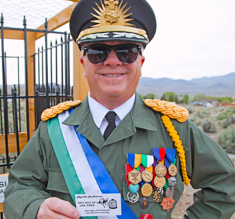 man with lots of medals poses in the republic of molossia