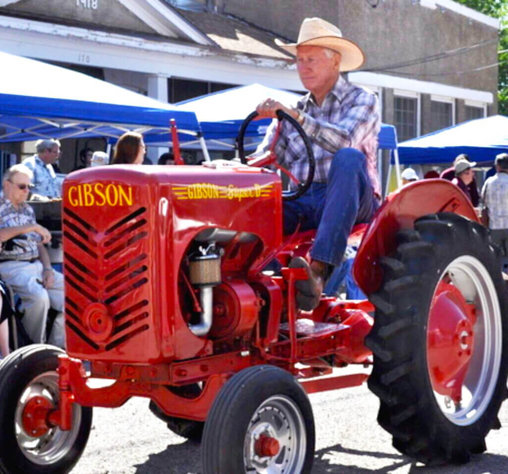 man riding a red tractor at dayton valley days